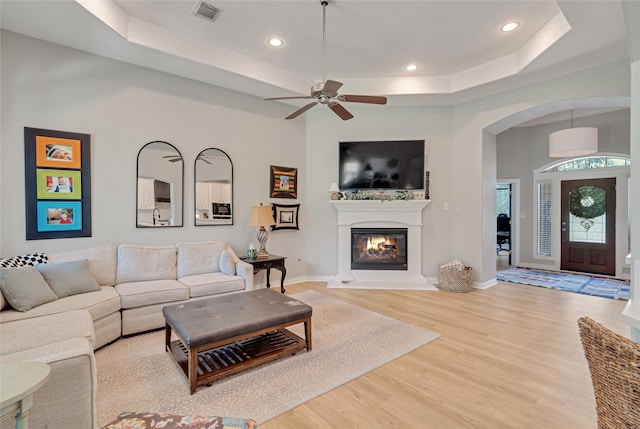 27326 S Karaugh Dr, Richmond, TX 77406 - living room with a raised ceiling, arched walkways, wood finished floors, a ceiling fan, and recessed lighting