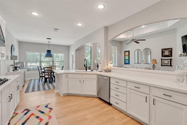 27326 S Karaugh Dr, Richmond, TX 77406 - kitchen with stainless steel dishwasher, arched walkways, a sink, recessed lighting, and light wood-style flooring