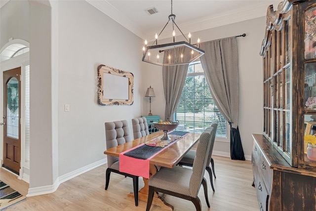 27326 S Karaugh Dr, Richmond, TX 77406 - dining room with a chandelier, light wood-type flooring, baseboards, crown molding, and arched walkways