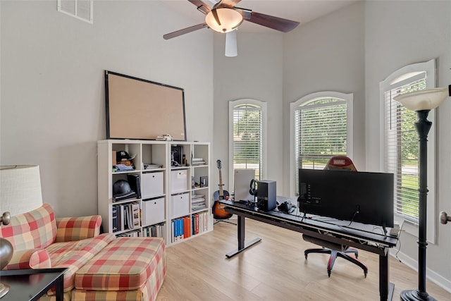 27326 S Karaugh Dr, Richmond, TX 77406 - office with light wood-style flooring, a ceiling fan, and a high ceiling