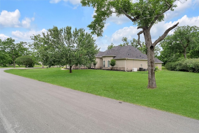 27326 S Karaugh Dr, Richmond, TX 77406 - view of front facade featuring stucco siding, a front lawn, and stone siding