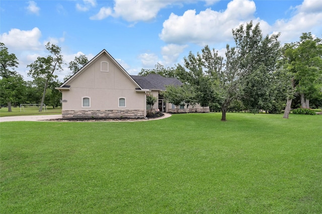 27326 S Karaugh Dr, Richmond, TX 77406 - view of home's exterior with a lawn and stucco siding