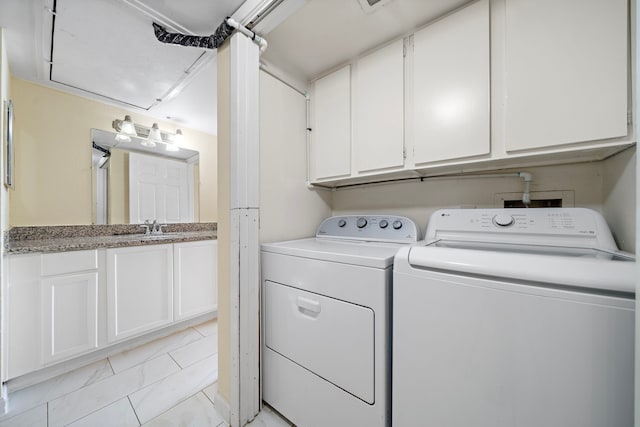 8429 Hearth Dr Unit 8, Houston, TX 77054 - laundry area featuring washer and clothes dryer, cabinet space, and light tile patterned floors
