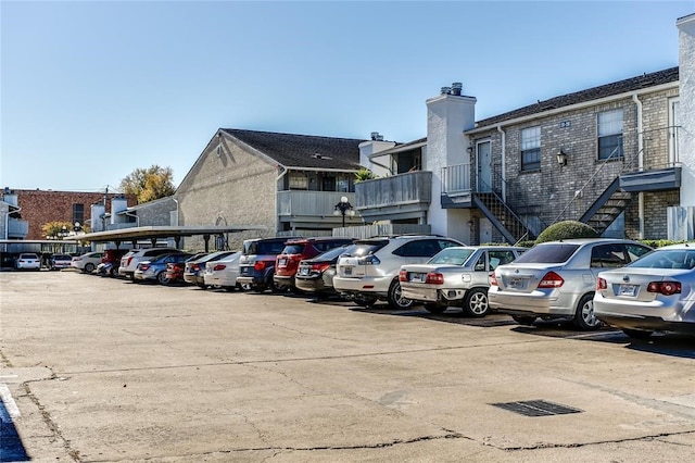 8787 Brae Acres Rd Unit 403, Houston, TX 77074 - uncovered parking lot featuring stairway