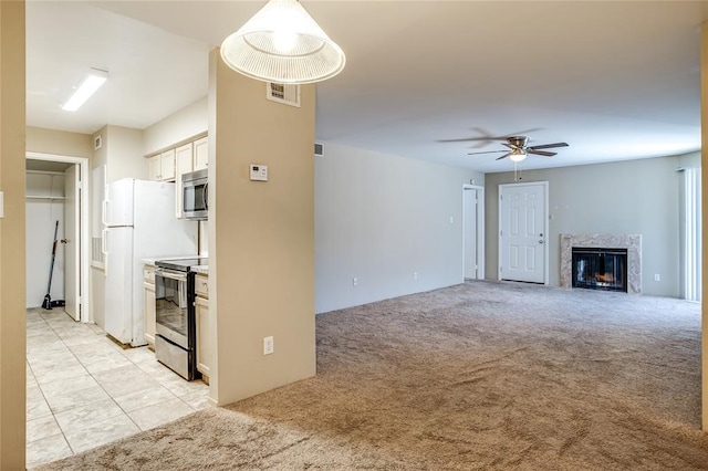 8787 Brae Acres Rd Unit 403, Houston, TX 77074 - unfurnished living room featuring a premium fireplace, ceiling fan, and light colored carpet