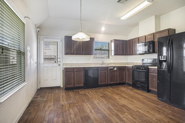 21606 Micheala Way, Humble, TX 77338 - kitchen featuring black appliances, vaulted ceiling, dark wood finished floors, dark brown cabinetry, and hanging light fixtures