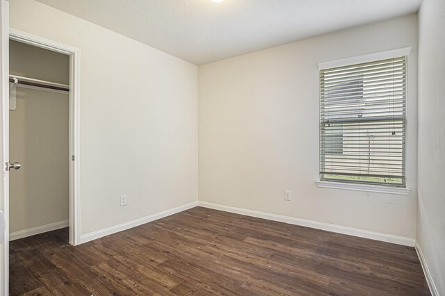21606 Micheala Way, Humble, TX 77338 - unfurnished bedroom with dark wood-style floors and baseboards
