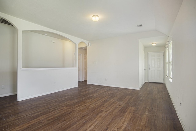 21606 Micheala Way, Humble, TX 77338 - spare room featuring dark wood-type flooring, baseboards, and arched walkways