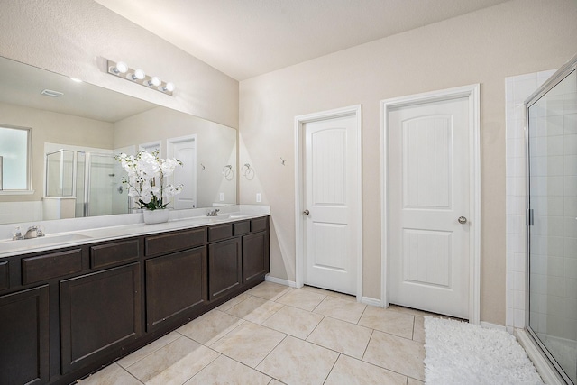 9407 Mineral Rock Ln, Richmond, TX 77407 - bathroom with double vanity, a stall shower, and tile patterned flooring