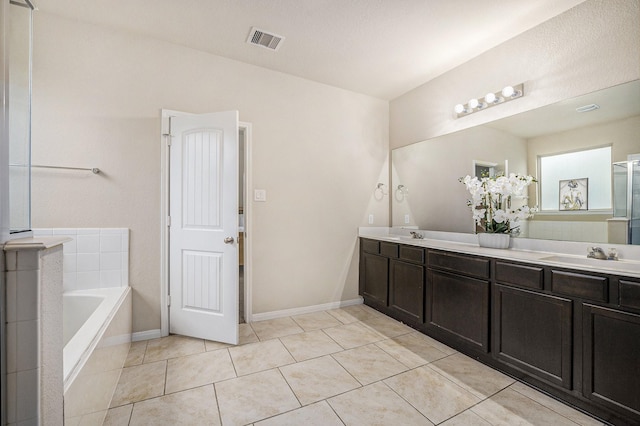 9407 Mineral Rock Ln, Richmond, TX 77407 - bathroom with double vanity, a bath, tile patterned flooring, and baseboards