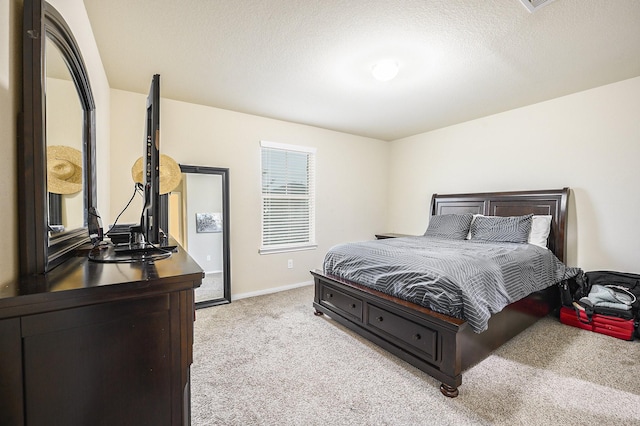 9407 Mineral Rock Ln, Richmond, TX 77407 - bedroom featuring light carpet, baseboards, and a textured ceiling