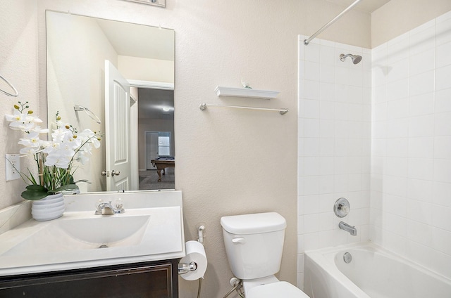 9407 Mineral Rock Ln, Richmond, TX 77407 - bathroom featuring toilet, vanity, tub / shower combination, and a textured wall