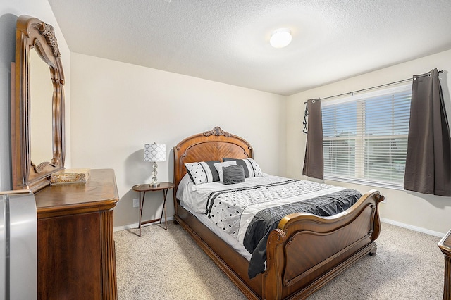 9407 Mineral Rock Ln, Richmond, TX 77407 - bedroom with light carpet, baseboards, and a textured ceiling