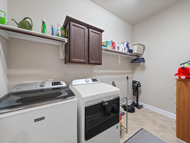 4202 Lodge Ranch Ct, Fulshear, TX 77441 - laundry room with cabinet space, independent washer and dryer, light tile patterned floors, and baseboards