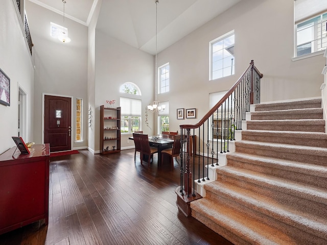 4202 Lodge Ranch Ct, Fulshear, TX 77441 - foyer entrance featuring stairway, a towering ceiling, a chandelier, dark wood-type flooring, and baseboards