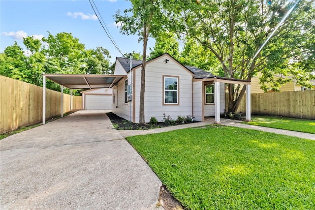 807 Aron St, Baytown, TX 77520 - ranch-style house featuring concrete driveway, an outbuilding, a carport, and an attached garage