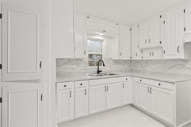 807 Aron St, Baytown, TX 77520 - kitchen with a sink, white cabinets, decorative backsplash, and light marble finish flooring