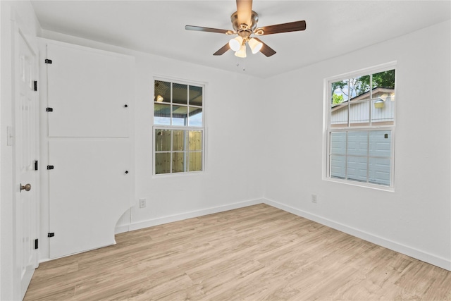 807 Aron St, Baytown, TX 77520 - spare room with light wood finished floors, ceiling fan, and baseboards