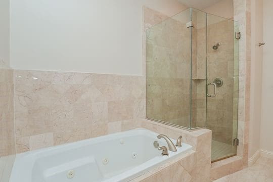 5422 Gibson St Unit A, Houston, TX 77007 - bathroom featuring a stall shower and a tub with jets