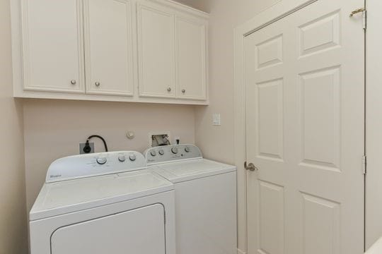 5422 Gibson St Unit A, Houston, TX 77007 - laundry area featuring cabinet space and washing machine and dryer