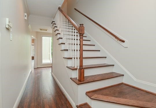 5422 Gibson St Unit A, Houston, TX 77007 - staircase with wood-type flooring, crown molding, and baseboards
