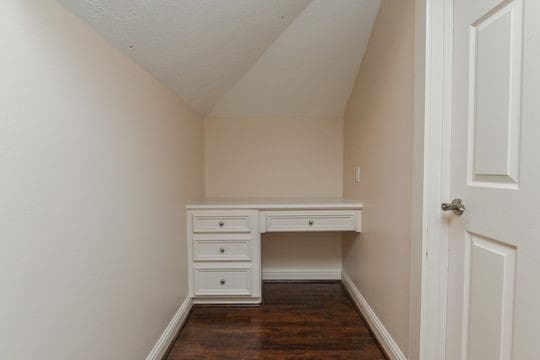 5422 Gibson St Unit A, Houston, TX 77007 - unfurnished office featuring dark wood-style floors, built in study area, baseboards, and vaulted ceiling