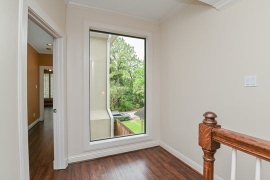 5422 Gibson St Unit A, Houston, TX 77007 - doorway featuring crown molding, dark wood finished floors, and baseboards