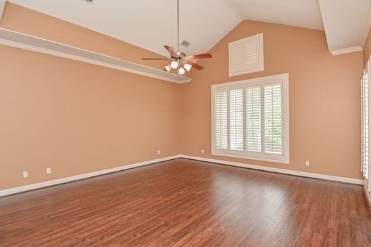 5422 Gibson St Unit A, Houston, TX 77007 - empty room featuring wood finished floors, baseboards, lofted ceiling, ceiling fan, and crown molding
