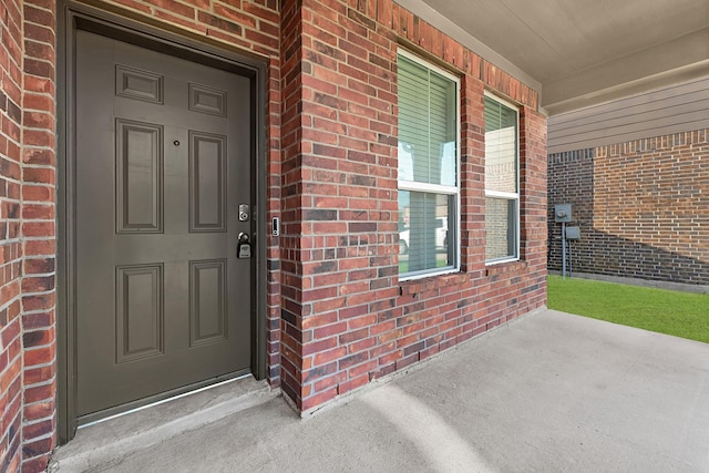 14806 Meadow Acre Trl, Houston, TX 77049 - view of exterior entry with brick siding and a porch