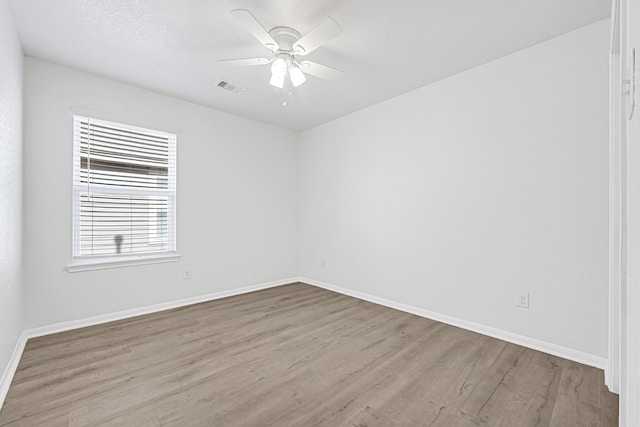 14806 Meadow Acre Trl, Houston, TX 77049 - spare room with wood finished floors, a ceiling fan, and baseboards