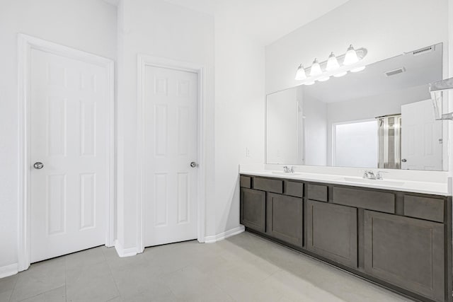 14806 Meadow Acre Trl, Houston, TX 77049 - full bath featuring double vanity, baseboards, and tile patterned floors