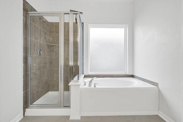 14806 Meadow Acre Trl, Houston, TX 77049 - full bathroom with a stall shower, a garden tub, baseboards, and tile patterned floors