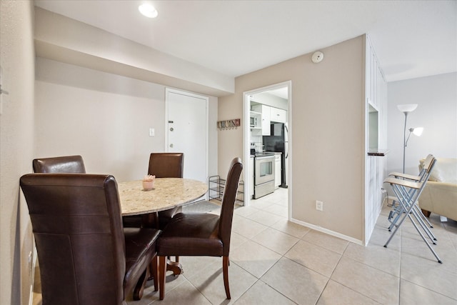 4631 Wild Indigo St Unit 571, Houston, TX 77027 - dining area featuring light tile patterned floors and baseboards