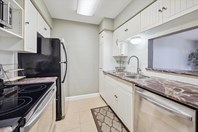 4631 Wild Indigo St Unit 571, Houston, TX 77027 - kitchen with appliances with stainless steel finishes, a sink, tasteful backsplash, white cabinets, and light tile patterned flooring