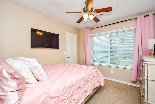 18178 Holly Green Dr, Houston, TX 77084 - bedroom featuring light colored carpet, baseboards, ceiling fan, and a textured ceiling