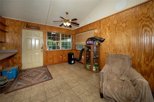 5332 County Road 1180, Kennard, TX 75847 - living area with wood walls, lofted ceiling, and ceiling fan