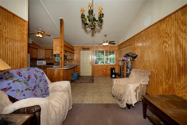 5332 County Road 1180, Kennard, TX 75847 - living area featuring ceiling fan, lofted ceiling, wooden walls, and carpet floors