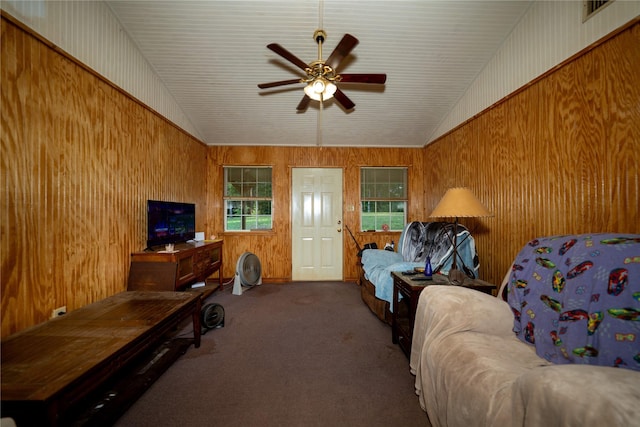 5332 County Road 1180, Kennard, TX 75847 - carpeted living area with ceiling fan, wood walls, and vaulted ceiling