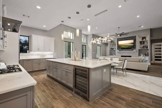 27457 S Lazy Meadow Way, Spring, TX 77386 - kitchen with wine cooler, gray cabinets, stainless steel gas cooktop, a ceiling fan, and light stone countertops