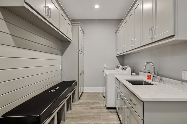 27457 S Lazy Meadow Way, Spring, TX 77386 - washroom featuring washer and dryer, recessed lighting, light wood-style flooring, cabinet space, and baseboards