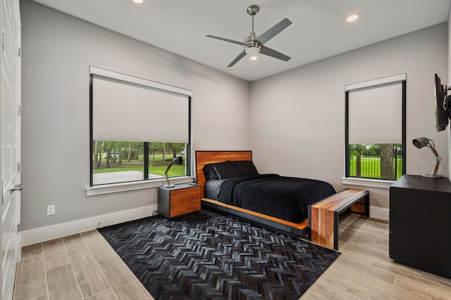 27457 S Lazy Meadow Way, Spring, TX 77386 - bedroom with multiple windows, wood finished floors, baseboards, recessed lighting, and a ceiling fan