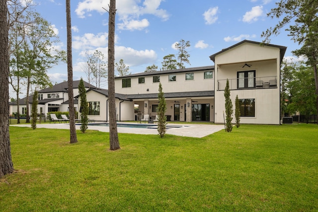 27457 S Lazy Meadow Way, Spring, TX 77386 - rear view of property featuring a ceiling fan, a balcony, a lawn, a patio area, and cooling unit