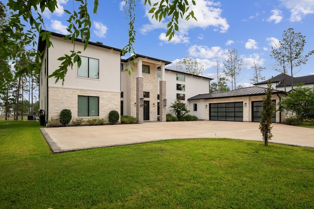 27457 S Lazy Meadow Way, Spring, TX 77386 - modern home with stone siding, stucco siding, concrete driveway, a front lawn, and a garage