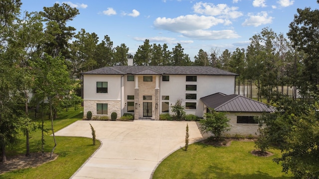 27457 S Lazy Meadow Way, Spring, TX 77386 - contemporary house featuring stone siding, stucco siding, a front yard, and driveway