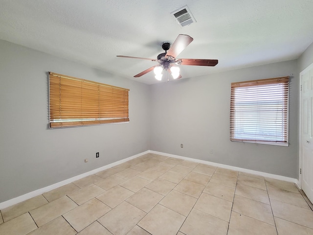1703 Raintree St, Baytown, TX 77520 - spare room featuring a ceiling fan, light tile patterned flooring, and a textured ceiling