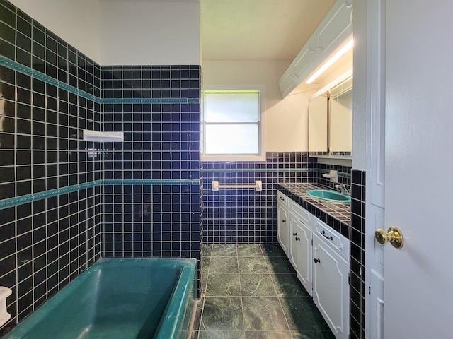 1703 Raintree St, Baytown, TX 77520 - full bath featuring vanity, tile walls, wainscoting, and washtub / shower combination