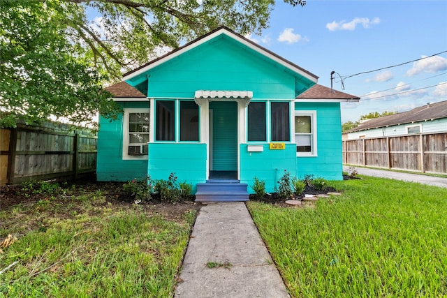 706 E Hunnicutt St, Baytown, TX 77520 - view of front of home with a shingled roof, cooling unit, and a sunroom