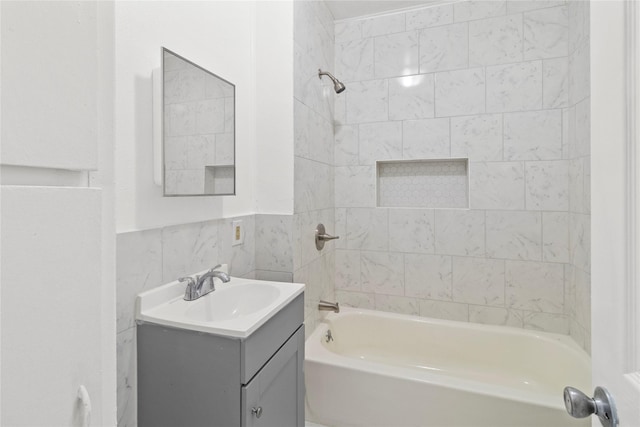 706 E Hunnicutt St, Baytown, TX 77520 - full bathroom featuring vanity, shower / bathtub combination, and tile walls