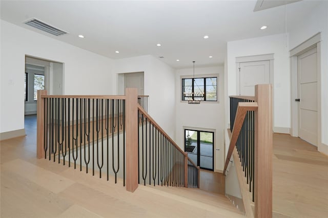 1253 Lamonte Ln, Houston, TX 77018 - staircase featuring attic access, plenty of natural light, a chandelier, wood finished floors, and recessed lighting