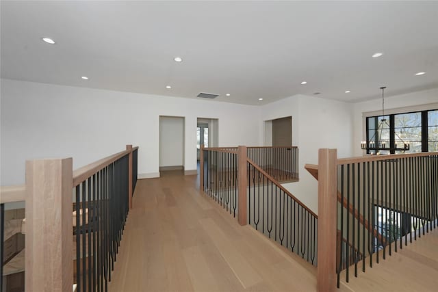 1253 Lamonte Ln, Houston, TX 77018 - hall featuring wood finished floors, an upstairs landing, recessed lighting, a chandelier, and baseboards